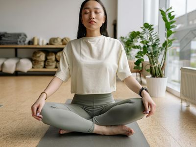 A person meditating peacefully after a yoga session.